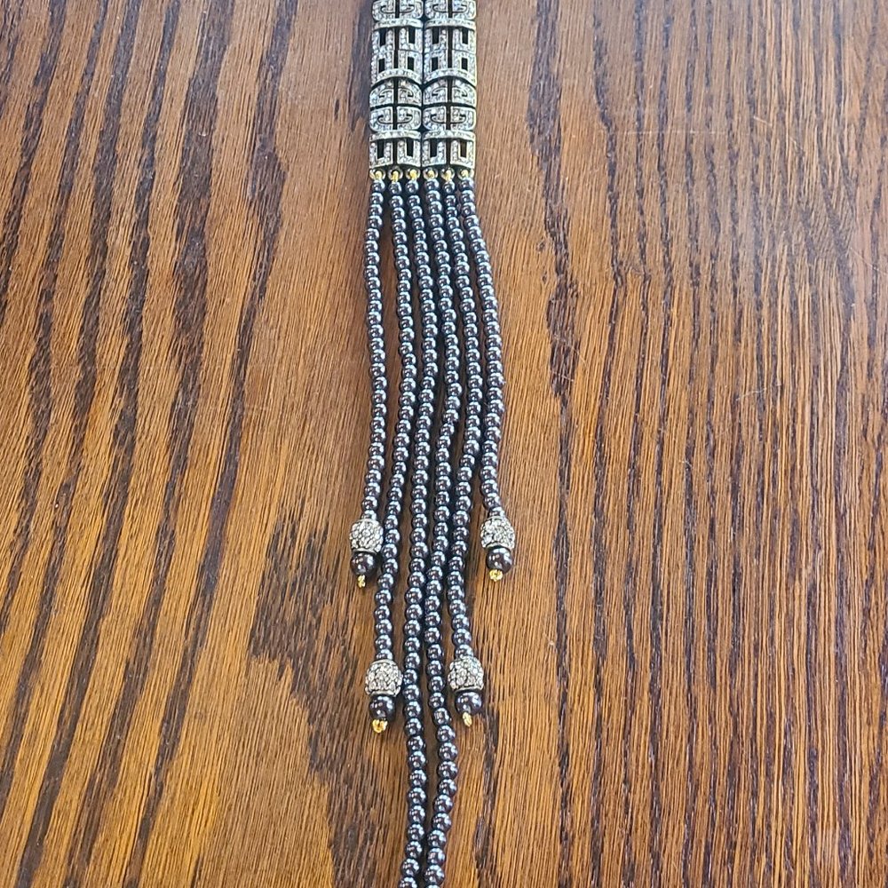 Three strand charcoal grey pearls.